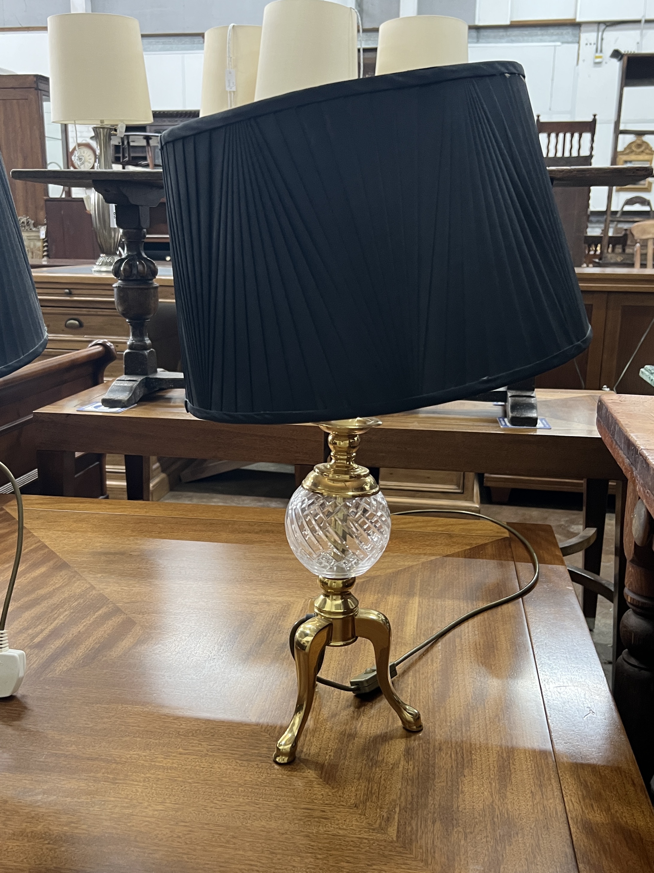 A pair of contemporary brass and clear glass tripod table lamps, height including shades 60cm